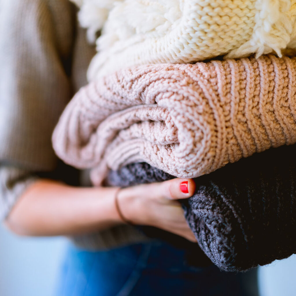 Woman carrying washed and dried clothes